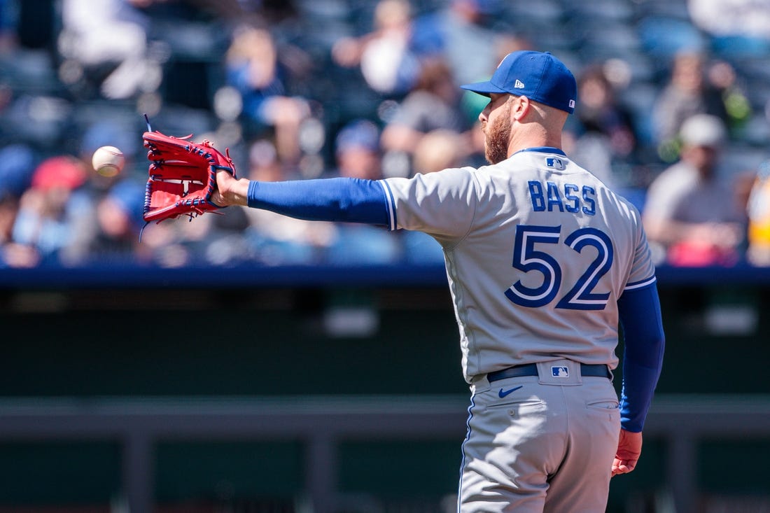 Apr 6, 2023; Kansas City, Missouri, USA; Toronto Blue Jays relief pitcher Anthony Bass (52) reaches for a throw during the seventh inning against the Kansas City Royals at Kauffman Stadium. Mandatory Credit: William Purnell-USA TODAY Sports