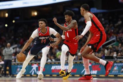 Apr 9, 2023; Washington, District of Columbia, USA;Washington Wizards forward Isaiah Todd (14) dribbles the ball as Houston Rockets guard Jalen Green (4) defends in the third quarter at Capital One Arena. Mandatory Credit: Geoff Burke-USA TODAY Sports