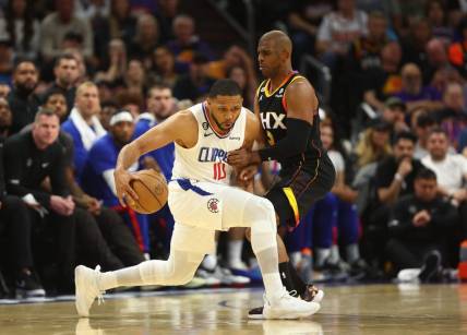 Apr 18, 2023; Phoenix, Arizona, USA; Los Angeles Clippers guard Eric Gordon (10) moves the ball against Phoenix Suns guard Chris Paul (3) in the second half during game two of the 2023 NBA playoffs at Footprint Center. Mandatory Credit: Mark J. Rebilas-USA TODAY Sports