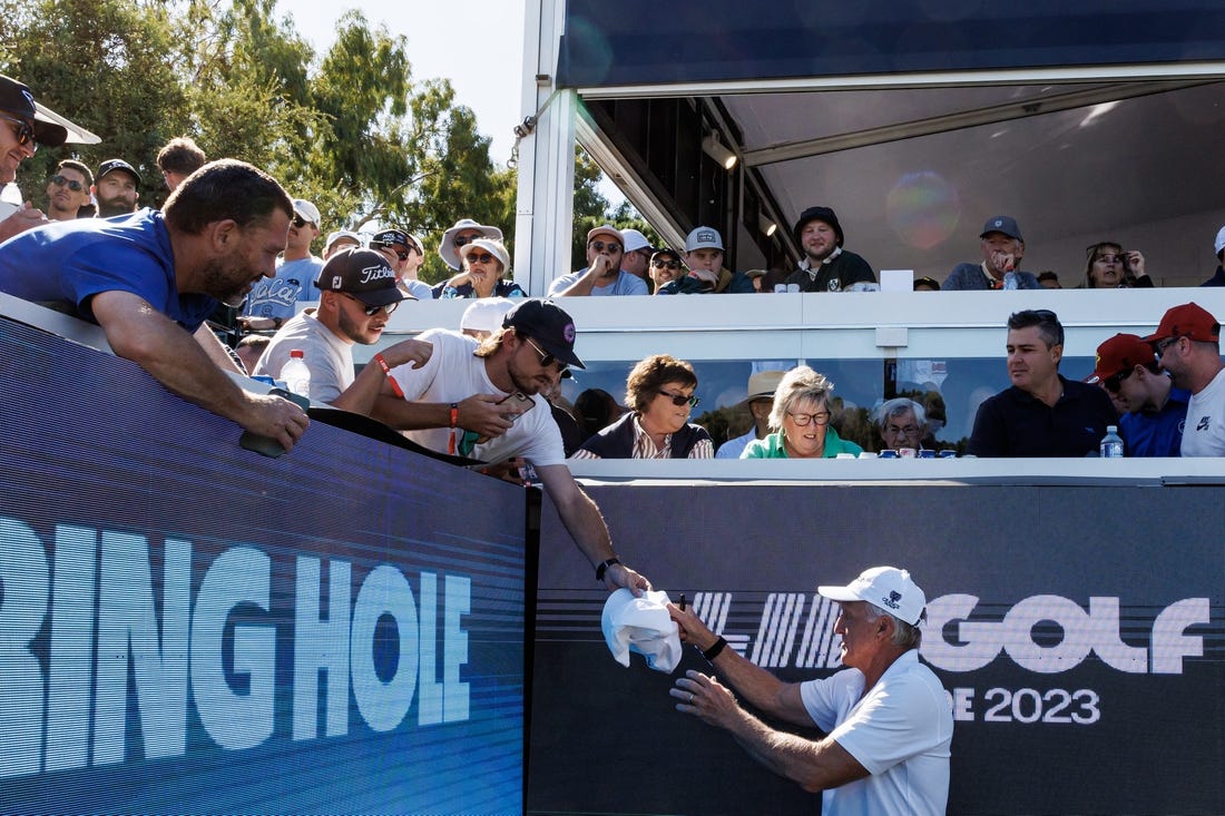 Apr 21, 2023; Adelaide, South Australia AUS;  Greg Norman signs autographs on the twelfth hole during the first round of LIV Golf Adelaide golf tournament at Grange Golf Club. Mandatory Credit: Mike Frey-USA TODAY Sports