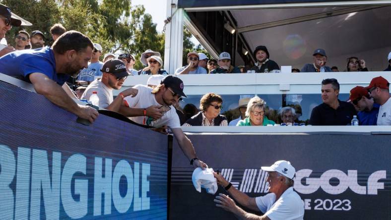 Apr 21, 2023; Adelaide, South Australia AUS;  Greg Norman signs autographs on the twelfth hole during the first round of LIV Golf Adelaide golf tournament at Grange Golf Club. Mandatory Credit: Mike Frey-USA TODAY Sports