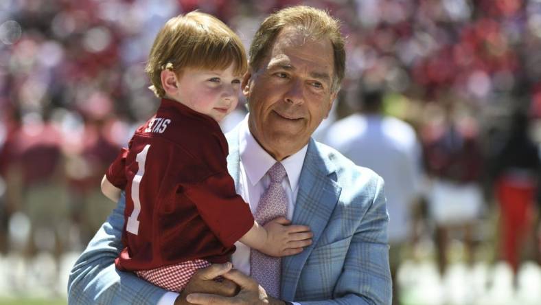 Apr 22, 2023; Tuscaloosa, AL, USA; Alabama head coach Nick Saban holds his grandson before the A-Day game at Bryant-Denny Stadium. Mandatory Credit: Gary Cosby-USA TODAY Sports