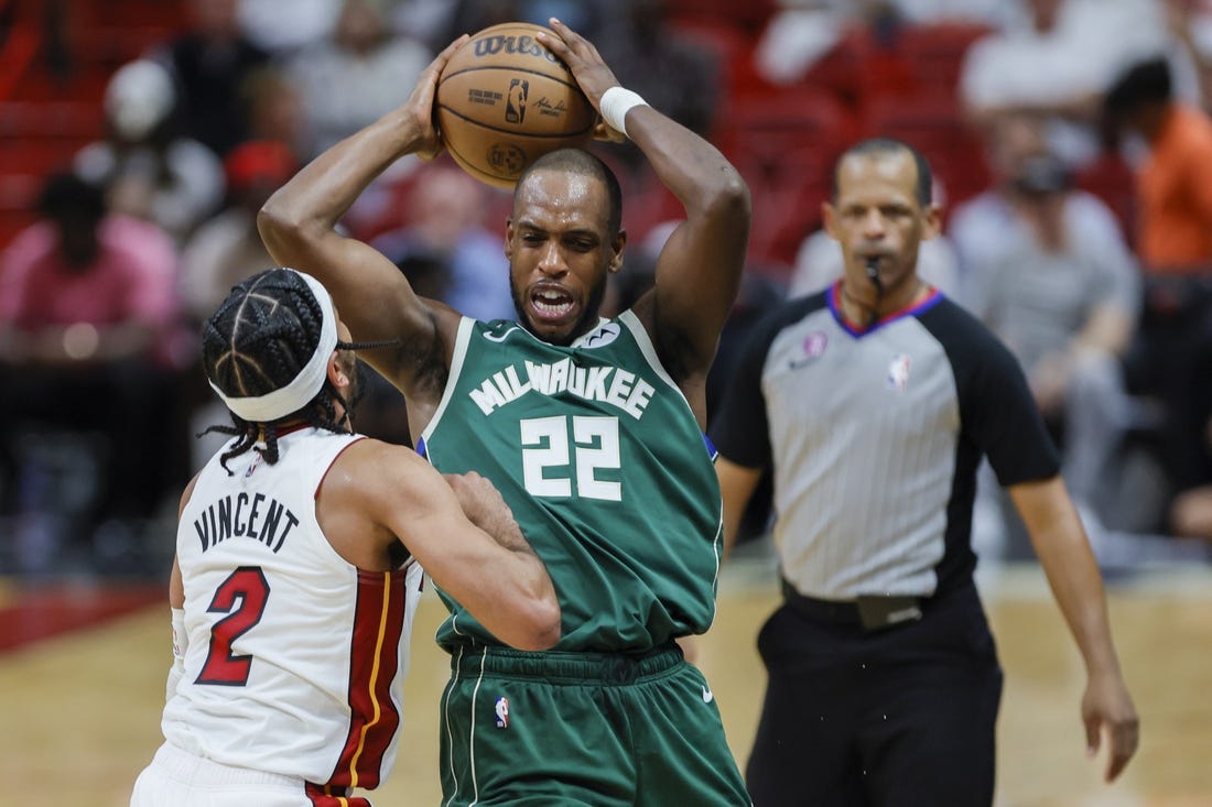 Apr 22, 2023; Miami, Florida, USA; Milwaukee Bucks forward Khris Middleton (22) protects the basketball from Miami Heat guard Gabe Vincent (2) in the third quarter during game three of the 2023 NBA Playoffs at Kaseya Center. Mandatory Credit: Sam Navarro-USA TODAY Sports