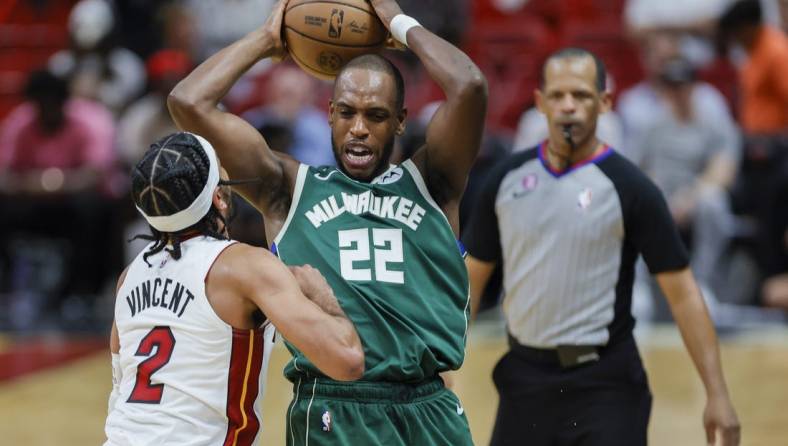 Apr 22, 2023; Miami, Florida, USA; Milwaukee Bucks forward Khris Middleton (22) protects the basketball from Miami Heat guard Gabe Vincent (2) in the third quarter during game three of the 2023 NBA Playoffs at Kaseya Center. Mandatory Credit: Sam Navarro-USA TODAY Sports