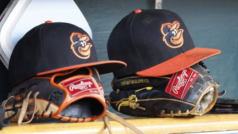 Apr 27, 2023; Detroit, Michigan, USA;  Baltimore Orioles hats and glove sits in dugout in the second inning against the Detroit Tigers at Comerica Park. Mandatory Credit: Rick Osentoski-USA TODAY Sports