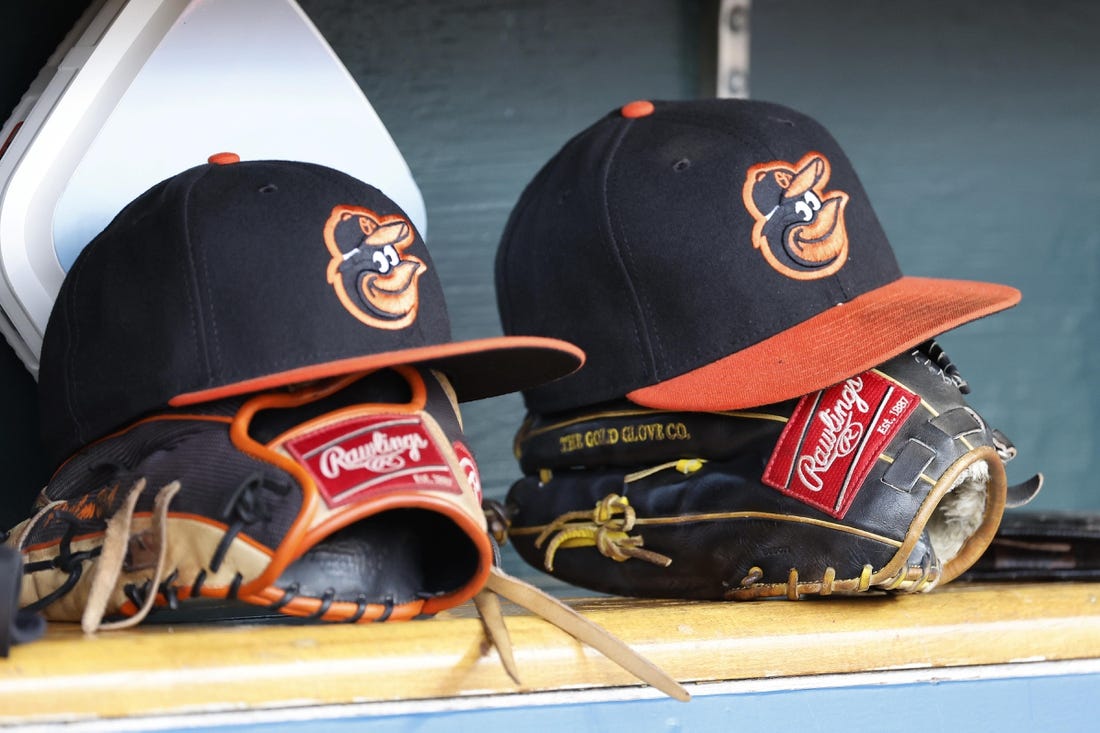 Apr 27, 2023; Detroit, Michigan, USA;  Baltimore Orioles hats and glove sits in dugout in the second inning against the Detroit Tigers at Comerica Park. Mandatory Credit: Rick Osentoski-USA TODAY Sports