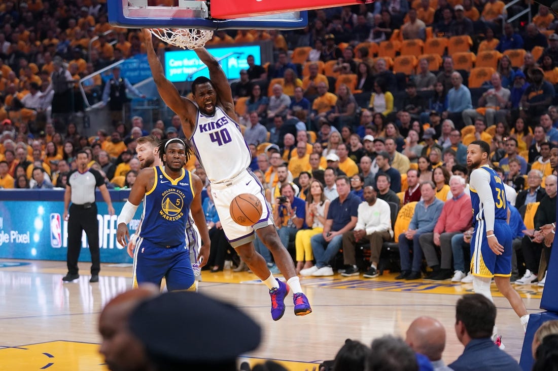 Apr 28, 2023; San Francisco, California, USA; Sacramento Kings forward Harrison Barnes (40) dunks the ball in front of Golden State Warriors forward Kevon Looney (5) in the first quarter during game six of the 2023 NBA playoffs at the Chase Center. Mandatory Credit: Cary Edmondson-USA TODAY Sports