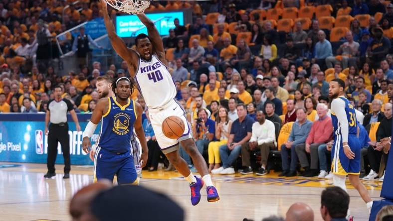 Apr 28, 2023; San Francisco, California, USA; Sacramento Kings forward Harrison Barnes (40) dunks the ball in front of Golden State Warriors forward Kevon Looney (5) in the first quarter during game six of the 2023 NBA playoffs at the Chase Center. Mandatory Credit: Cary Edmondson-USA TODAY Sports