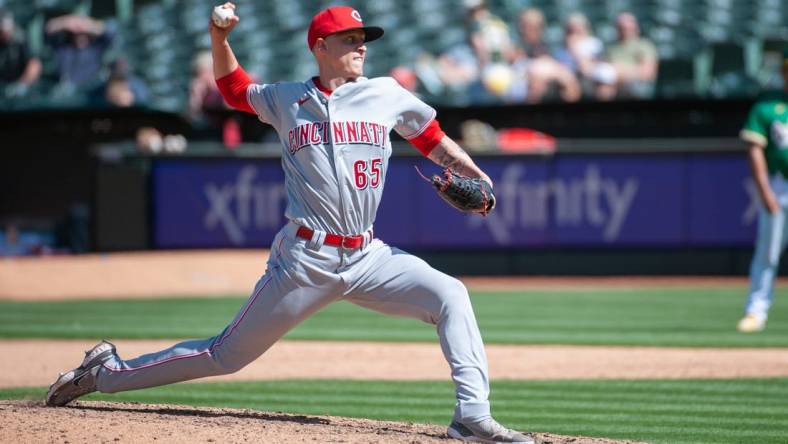 Apr 29, 2023; Oakland, California, USA; Cincinnati Reds relief pitcher Casey Legumina (65) throws a pitch during the eighth inning against the Oakland Athletics at RingCentral Coliseum. Mandatory Credit: Ed Szczepanski-USA TODAY Sports