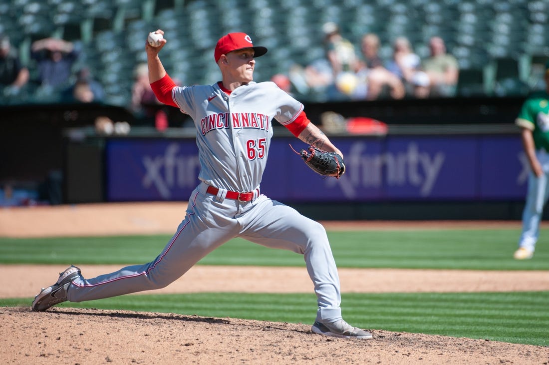 Apr 29, 2023; Oakland, California, USA; Cincinnati Reds relief pitcher Casey Legumina (65) throws a pitch during the eighth inning against the Oakland Athletics at RingCentral Coliseum. Mandatory Credit: Ed Szczepanski-USA TODAY Sports
