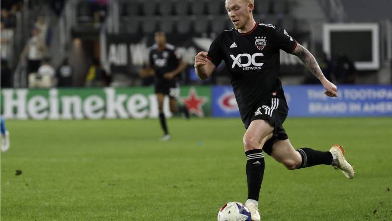 Apr 29, 2023; Washington, District of Columbia, USA; D.C. United midfielder Lewis O'Brien (17) dribbles the ball against Charlotte FC at Audi Field. Mandatory Credit: Geoff Burke-USA TODAY Sports