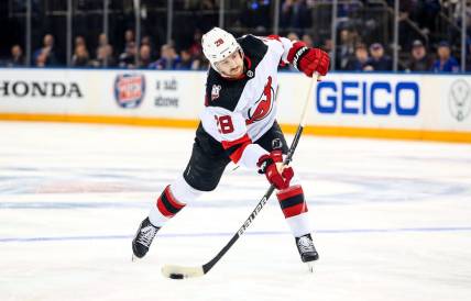 Apr 29, 2023; New York, New York, USA; New Jersey Devils defenseman Damon Severson (28) takes a shot against the New York Rangers during the third period in game six of the first round of the 2023 Stanley Cup Playoffs at Madison Square Garden. Mandatory Credit: Danny Wild-USA TODAY Sports