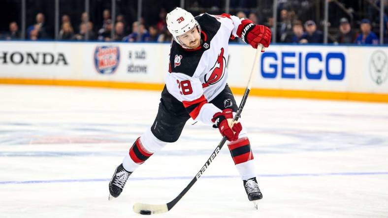 Apr 29, 2023; New York, New York, USA; New Jersey Devils defenseman Damon Severson (28) takes a shot against the New York Rangers during the third period in game six of the first round of the 2023 Stanley Cup Playoffs at Madison Square Garden. Mandatory Credit: Danny Wild-USA TODAY Sports