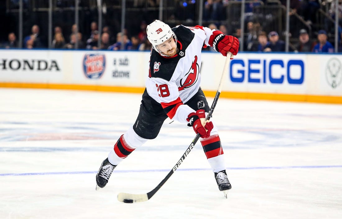 Apr 29, 2023; New York, New York, USA; New Jersey Devils defenseman Damon Severson (28) takes a shot against the New York Rangers during the third period in game six of the first round of the 2023 Stanley Cup Playoffs at Madison Square Garden. Mandatory Credit: Danny Wild-USA TODAY Sports