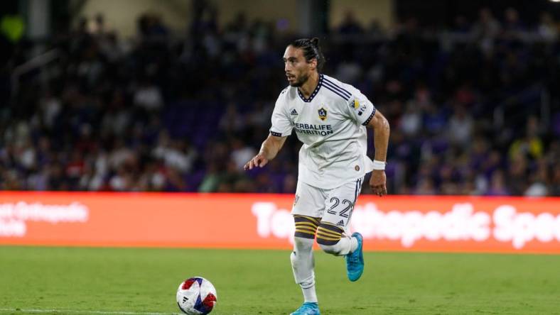 Apr 29, 2023; Orlando, Florida, USA; Los Angeles Galaxy defender Martin Caceres (22) dribbles the ball into Orlando City SC   s half in the second half at Exploria Stadium. Mandatory Credit: Morgan Tencza-USA TODAY Sports