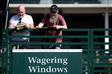 May 5, 2023; Louisville, KY, USA; Keith Shaffer and his son, Keith Shaffer Jr., prepare to make bets at Churchill Downs on Oaks Day, Friday, May 5, 2023, in Louisville, Ky. Mandatory Credit: Albert Cesare-USA TODAY Sports