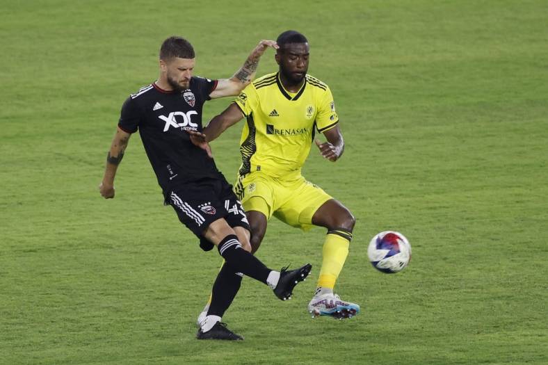 May 13, 2023; Washington, District of Columbia, USA; D.C. United midfielder Mateusz Klich (43) clears the ball from Nashville SC defender Shaq Moore (18) in the first half at Audi Field. Mandatory Credit: Geoff Burke-USA TODAY Sports