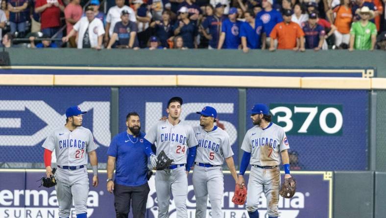 May 15, 2023; Houston, Texas, USA;  Chicago Cubs center fielder Cody Bellinger (24) comes out of the game after making a catch against the wall against the Houston Astros in the seventh inning at Minute Maid Park. Mandatory Credit: Thomas Shea-USA TODAY Sports