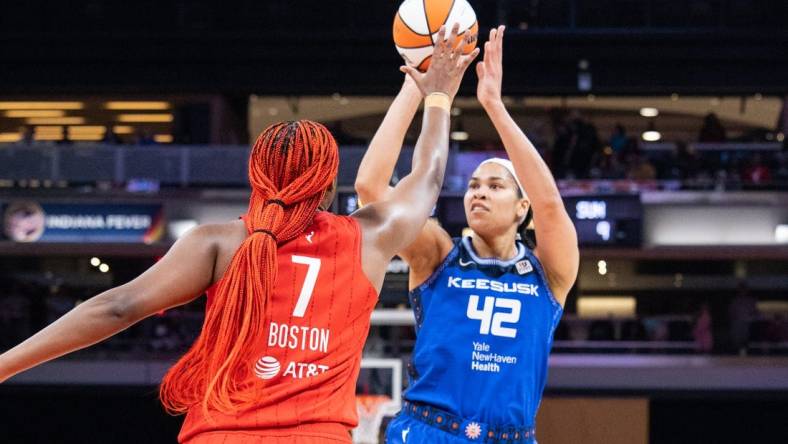 May 19, 2023; Indianapolis, Indiana, USA; Connecticut Sun center Brionna Jones (42) shoots the ball while Indiana Fever forward Aliyah Boston (7) defends in the first half at Gainbridge Fieldhouse. Mandatory Credit: Trevor Ruszkowski-USA TODAY Sports