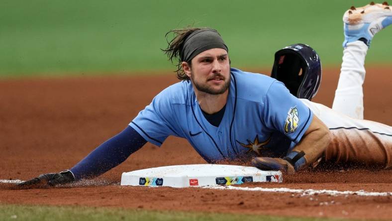 May 21, 2023; St. Petersburg, Florida, USA;  Tampa Bay Rays second baseman Brandon Lowe (8) steals third base against the Milwaukee Brewers in the eight inning at Tropicana Field. Mandatory Credit: Nathan Ray Seebeck-USA TODAY Sports