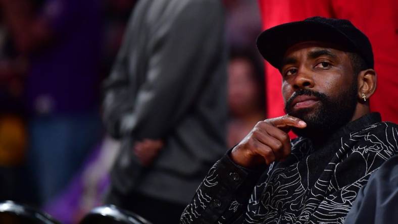 May 22, 2023; Los Angeles, California, USA; American professional basketball player Kyrie Irving watches from the baseline during the second quarter between the Los Angeles Lakers and the Denver Nuggets in game four of the Western Conference Finals for the 2023 NBA playoffs at Crypto.com Arena. Mandatory Credit: Gary A. Vasquez-USA TODAY Sports