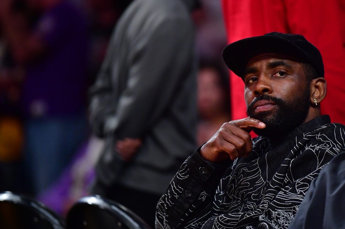 May 22, 2023; Los Angeles, California, USA; American professional basketball player Kyrie Irving watches from the baseline during the second quarter between the Los Angeles Lakers and the Denver Nuggets in game four of the Western Conference Finals for the 2023 NBA playoffs at Crypto.com Arena. Mandatory Credit: Gary A. Vasquez-USA TODAY Sports