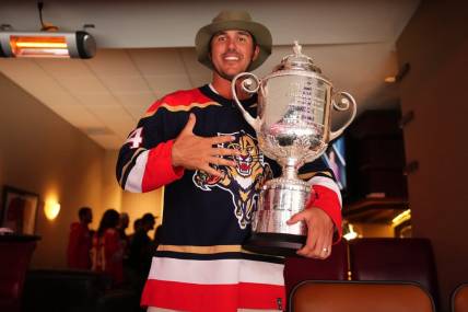 May 22, 2023; Sunrise, Florida, USA; Pro golfer Brooks Koepka poses with the Wanamaker Trophy while attending Game 3 of the Eastern Conference Finals of the 2023 Stanley Cup Playoffs between the Florida Panthers and the Carolina Hurricanes at FLA Live Arena. Mandatory Credit: Jasen Vinlove-USA TODAY Sports