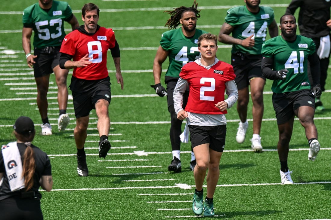 May 23, 2023; Florham Park, NJ, USA; New York Jets quarterback Aaron Rodgers (8) and quarterback Zach Wilson (2) warm up during OTA s at Atlantic Health Jets Training Center. Mandatory Credit: John Jones-USA TODAY Sports