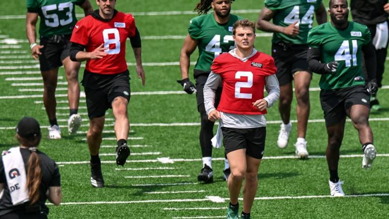 May 23, 2023; Florham Park, NJ, USA; New York Jets quarterback Aaron Rodgers (8) and quarterback Zach Wilson (2) warm up during OTA s at Atlantic Health Jets Training Center. Mandatory Credit: John Jones-USA TODAY Sports