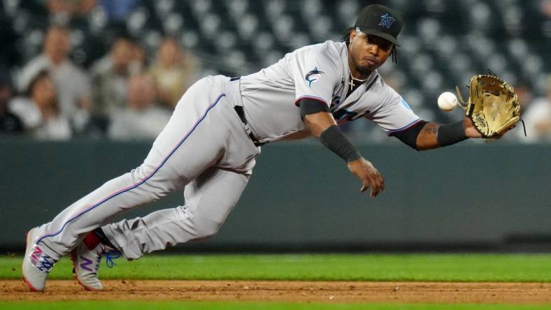 May 23, 2023; Denver, Colorado, USA; Miami Marlins third baseman Jean Segura (9) fields the ball in the sixth inning against the Colorado Rockies at Coors Field. Mandatory Credit: Ron Chenoy-USA TODAY Sports