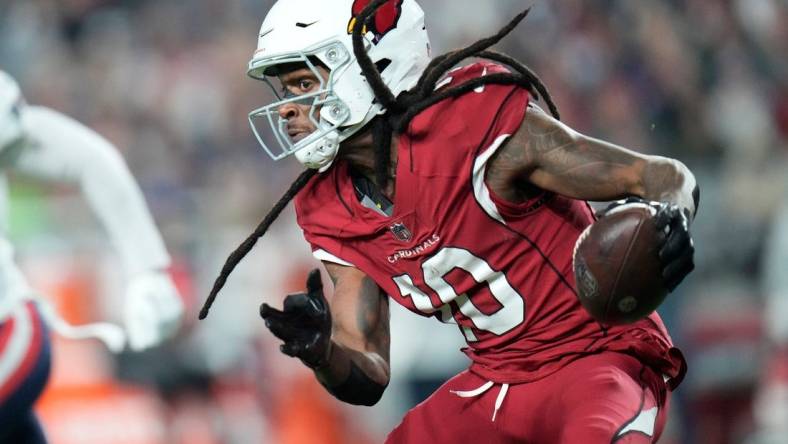 Arizona Cardinals wide receiver DeAndre Hopkins (10) runs with the ball after a catch against the New England Patriots during the third quarter at State Farm Stadium in Glendale on Dec. 12, 2022.