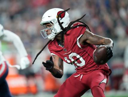 Arizona Cardinals wide receiver DeAndre Hopkins (10) runs with the ball after a catch against the New England Patriots during the third quarter at State Farm Stadium in Glendale on Dec. 12, 2022.