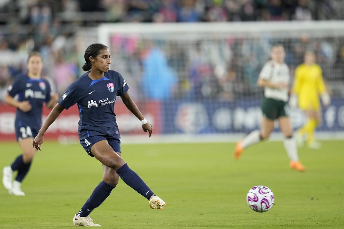 May 26, 2023; San Diego, California, USA; San Diego Wave FC defender Naomi Girma (4) plays the ball in the second half against Portland Thorns FC at Snapdragon Stadium. Mandatory Credit: Ray Acevedo-USA TODAY Sports