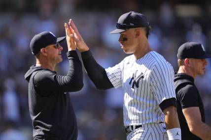 May 28, 2023; Bronx, New York, USA; New York Yankees manager Aaron Boone (17) and right fielder Aaron Judge (99) celebrate the victory against the San Diego Padres after the game at Yankee Stadium. Mandatory Credit: Gregory Fisher-USA TODAY Sports