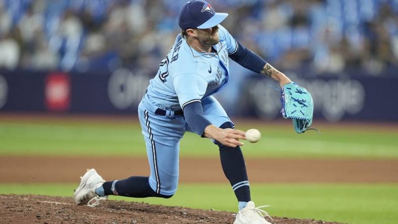 May 30, 2023; Toronto, Ontario, CAN; Toronto Blue Jays pitcher Adam Cimber (90) pitches to the Milwaukee Brewers during the eighth inning at Rogers Centre. Mandatory Credit: John E. Sokolowski-USA TODAY Sports