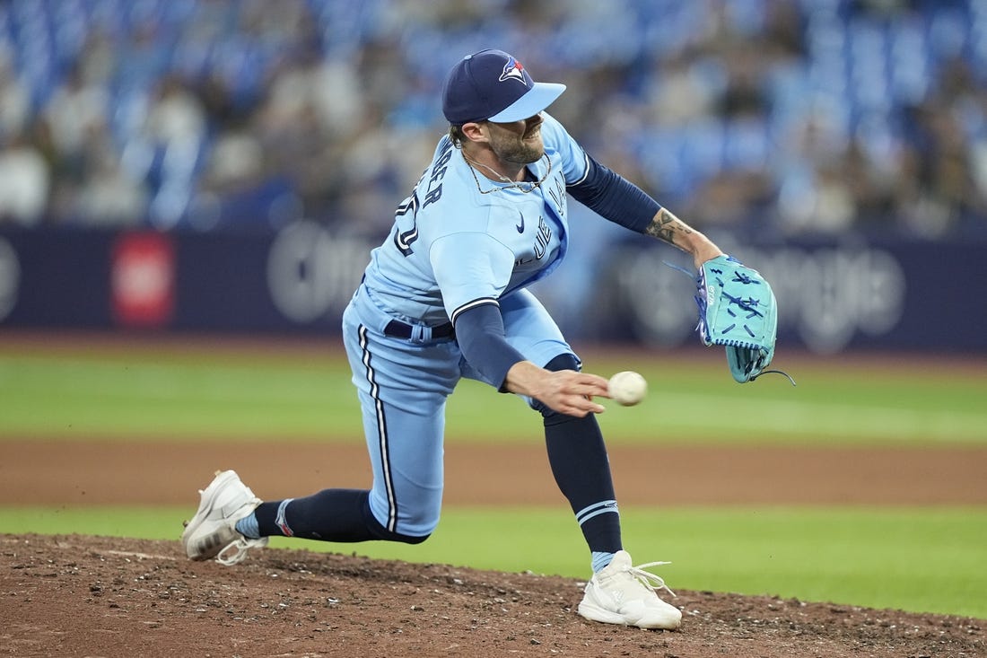 May 30, 2023; Toronto, Ontario, CAN; Toronto Blue Jays pitcher Adam Cimber (90) pitches to the Milwaukee Brewers during the eighth inning at Rogers Centre. Mandatory Credit: John E. Sokolowski-USA TODAY Sports