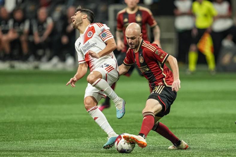 May 31, 2023; Atlanta, Georgia, USA; New England Revolution midfielder Carles Gil (10) reacts after a play on the ball by Atlanta United defender Andrew Gutman (15) during the second half at Mercedes-Benz Stadium. Mandatory Credit: Dale Zanine-USA TODAY Sports