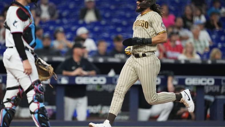 Jun 1, 2023; Miami, Florida, USA;  San Diego Padres right fielder Fernando Tatis Jr. (23) scores a run in the fourth inning against the Miami Marlins at loanDepot Park. Mandatory Credit: Jim Rassol-USA TODAY Sports