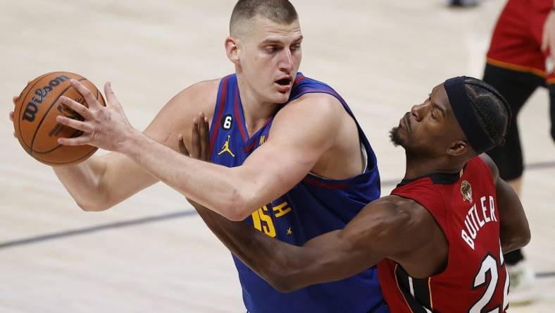 Jun 1, 2023; Denver, CO, USA; Denver Nuggets center Nikola Jokic (15) controls the ball while defended by Miami Heat forward Jimmy Butler (22) during the second quarter in game one of the 2023 NBA Finals at Ball Arena. Mandatory Credit: Isaiah J. Downing-USA TODAY Sports