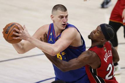 Jun 1, 2023; Denver, CO, USA; Denver Nuggets center Nikola Jokic (15) controls the ball while defended by Miami Heat forward Jimmy Butler (22) during the second quarter in game one of the 2023 NBA Finals at Ball Arena. Mandatory Credit: Isaiah J. Downing-USA TODAY Sports