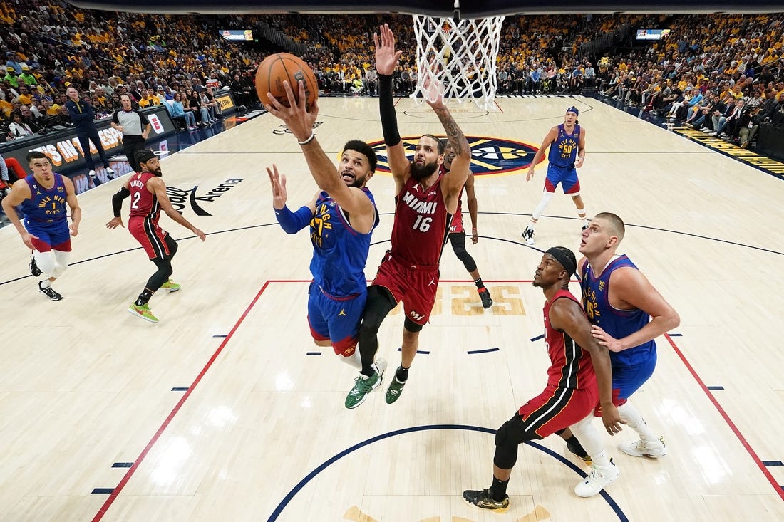 Jun 1, 2023; Denver, CO, USA; Denver Nuggets guard Jamal Murray (27) shoots the ball against Miami Heat forward Caleb Martin (16) during the first half in game one of the 2023 NBA Finals at Ball Arena. Mandatory Credit: Kyle Terada-USA TODAY Sports