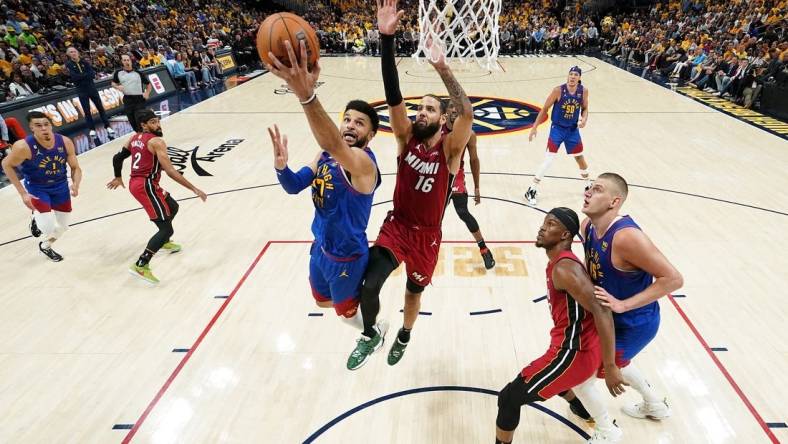 Jun 1, 2023; Denver, CO, USA; Denver Nuggets guard Jamal Murray (27) shoots the ball against Miami Heat forward Caleb Martin (16) during the first half in game one of the 2023 NBA Finals at Ball Arena. Mandatory Credit: Kyle Terada-USA TODAY Sports