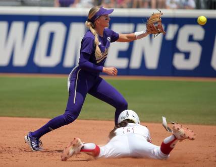 Utah's Haley Denning (3) slides to second as Washington's Rylee Holtorf (3) waits on the ball in the second inning of a softball game between Utah and Washington in the Women's College World Series at USA Softball Hall of Fame Stadium in Oklahoma City, Friday, June 2, 2023. Washington won 4-1.
