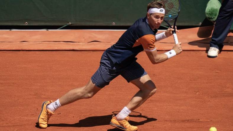 Jun 3, 2023; Paris,France; Casper Ruud (NOR) returns a shot during his match against Zhizhen Zhang (CHN) on day seven at Stade Roland-Garros. Mandatory Credit: Susan Mullane-USA TODAY Sports