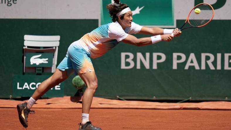 Jun 3, 2023; Paris,France; Zhizhen Zhang (CHN) returns a shot during his match against Casper Ruud (NOR) on day seven at Stade Roland-Garros. Mandatory Credit: Susan Mullane-USA TODAY Sports