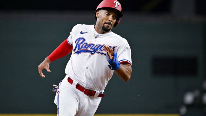 Jun 3, 2023; Arlington, Texas, USA; Texas Rangers second baseman Marcus Semien (2) scores against the Seattle Mariners during the second inning at Globe Life Field. Mandatory Credit: Jerome Miron-USA TODAY Sports