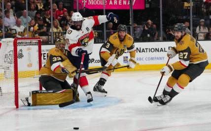 Jun 3, 2023; Las Vegas, Nevada, USA; Florida Panthers left wing Anthony Duclair (10) tries to get a shot off against Vegas Golden Knights goaltender Adin Hill (33) and Vegas Golden Knights defenseman Brayden McNabb (3) during the third period in game one of the 2023 Stanley Cup Final at T-Mobile Arena. Mandatory Credit: Stephen R. Sylvanie-USA TODAY Sports