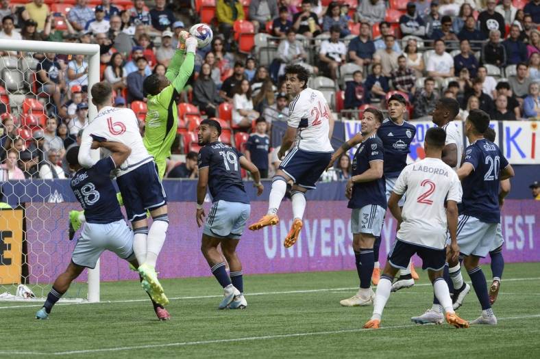 Jun 3, 2023; Vancouver, British Columbia, CAN;  Sporting Kansas City goalkeeper Kendall McIntosh (22) reaches for the ball as Vancouver Whitecaps FC forward Brian White (24) looks to head the ball during the first half at BC Place. Mandatory Credit: Anne-Marie Sorvin-USA TODAY Sports