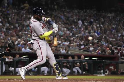 Jun 3, 2023; Phoenix, Arizona, USA; Atlanta Braves designated hitter Marcell Ozuna (20) hits an RBI single against the Arizona Diamondbacks during the fourth inning at Chase Field. Mandatory Credit: Joe Camporeale-USA TODAY Sports