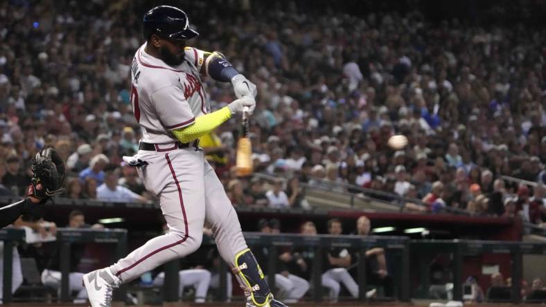 Jun 3, 2023; Phoenix, Arizona, USA; Atlanta Braves designated hitter Marcell Ozuna (20) hits an RBI single against the Arizona Diamondbacks during the fourth inning at Chase Field. Mandatory Credit: Joe Camporeale-USA TODAY Sports